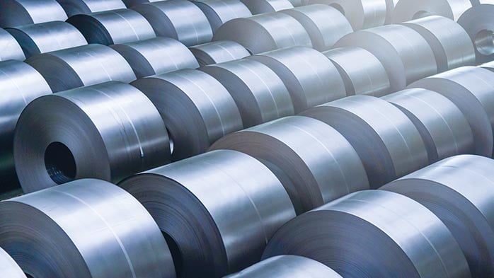 A collection of rolled steel coils, showcasing essential raw materials used in the stainless steel industry.