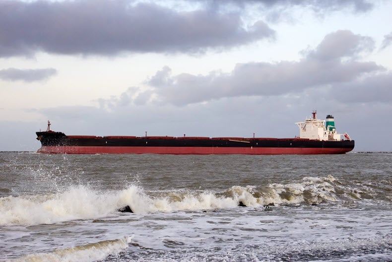 An oil tanker sailing through the sea, representing key issues in commodity markets and geopolitical tensions.