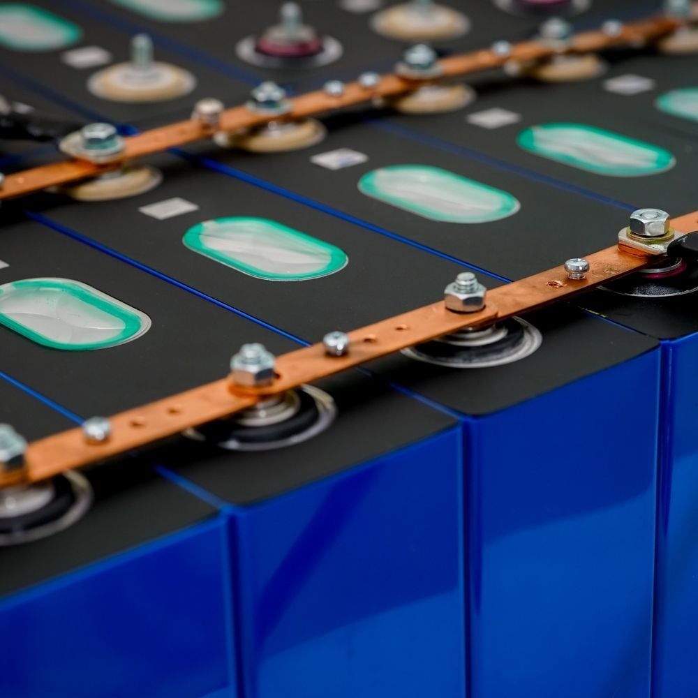 Image of a blue battery with copper strips running across the top showcasing CRU's battery materials commodity