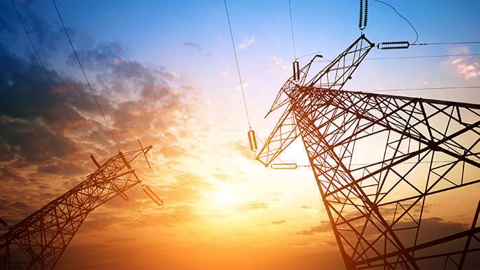 Power lines against a sunset background