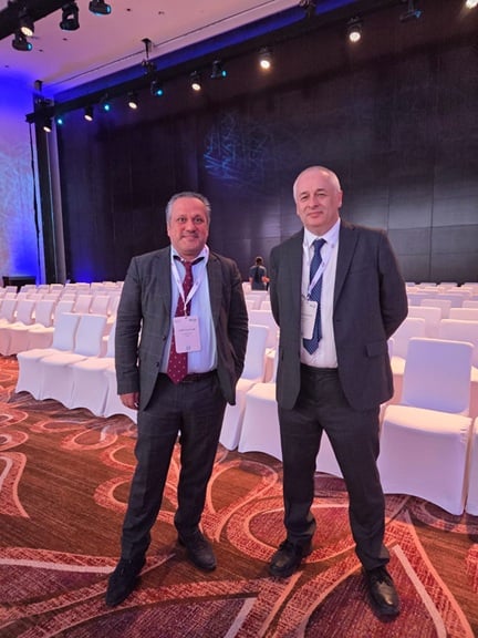 CRU Analysts posing in front of the stage at the ARABAL Conference