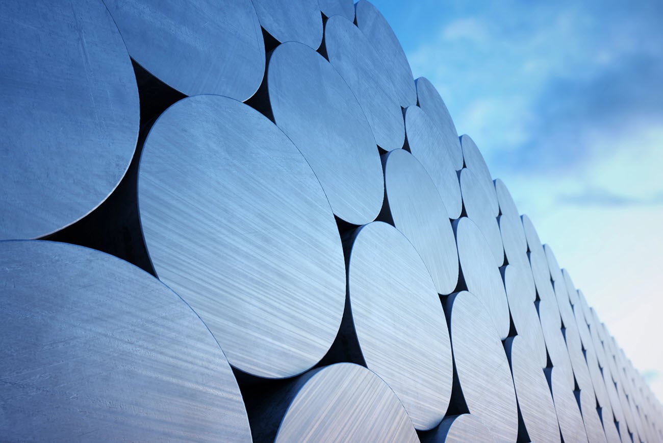 stack-of-aluminium-billets-on-a-cloudy-sky-background